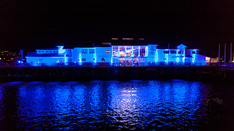 The Sea Center on Stearns Wharf, Santa Barbara lit up fo Light it Blue