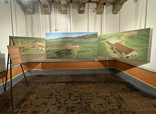 The north side of the gallery showing the entire 1833 Mission complex in the middle. On the is the image of the weaving building, kilns, corral and threshing floor. To the right are the upper and reservoirs and the grist mill. 